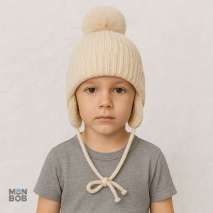Bonnet enfant beige avec pompon, protection contre le froid