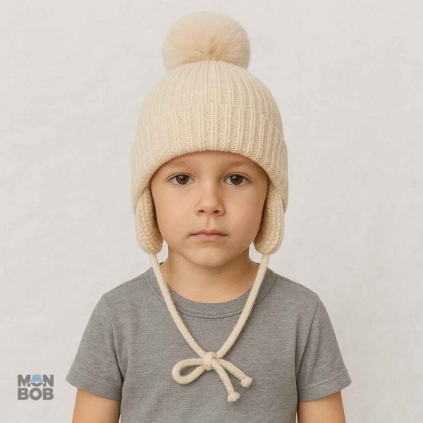 Bonnet enfant beige avec pompon, protection contre le froid